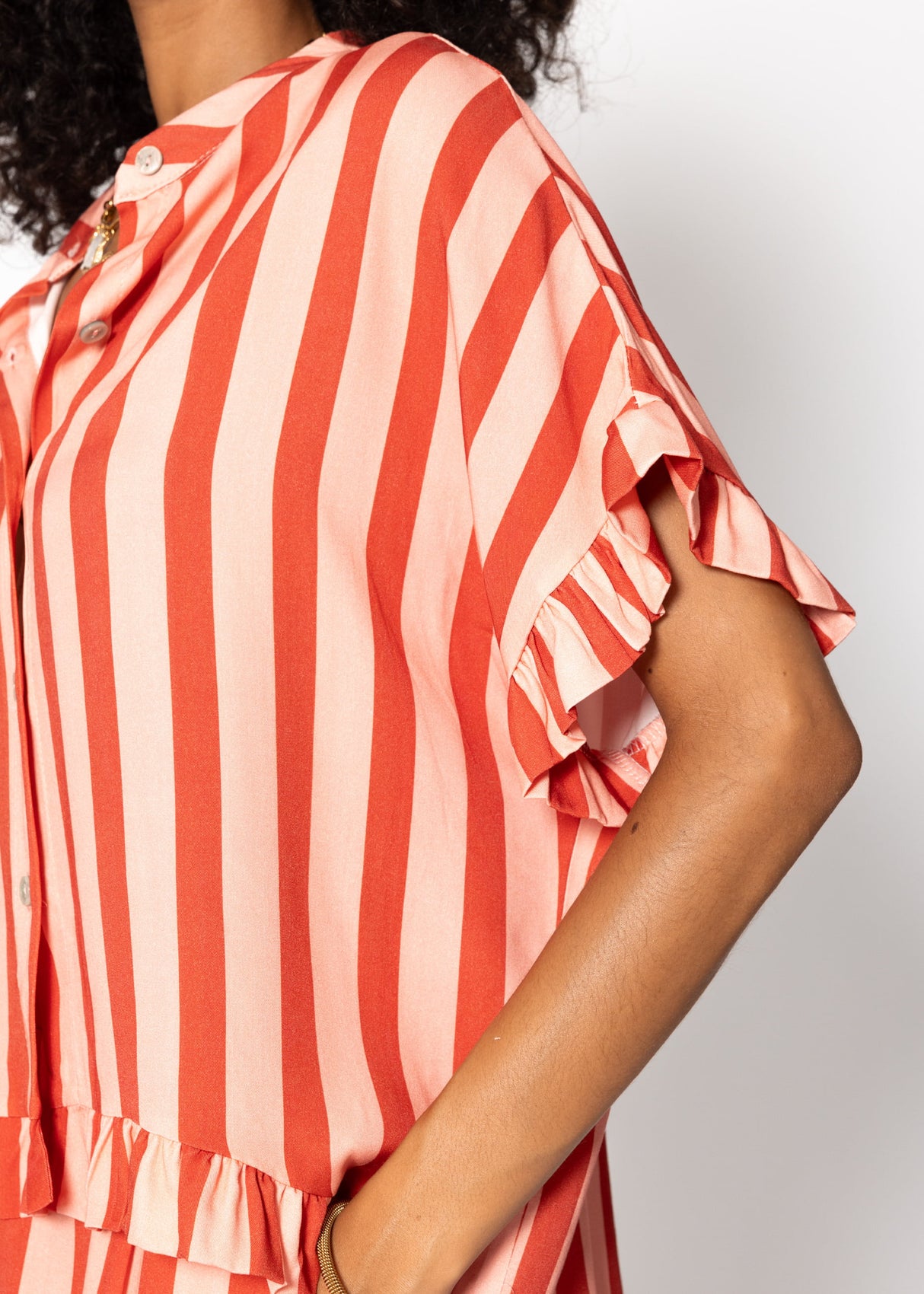 Striped blouse with ruffled hem - red