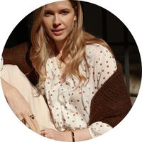Women's white blouse with a polka-dot pattern, styled with a brown cardigan from SASSYCLASSY