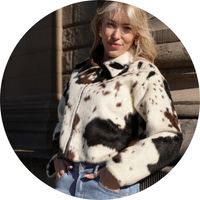 Woman wearing a black-and-white cow-print jacket – a trendy statement jacket from SASSYCLASSY