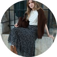 Women's black midi skirt with a white polka-dot pattern and a flowing midi-length cut, styled with a white top and a brown sweater – Skirts by SASSYCLASSY