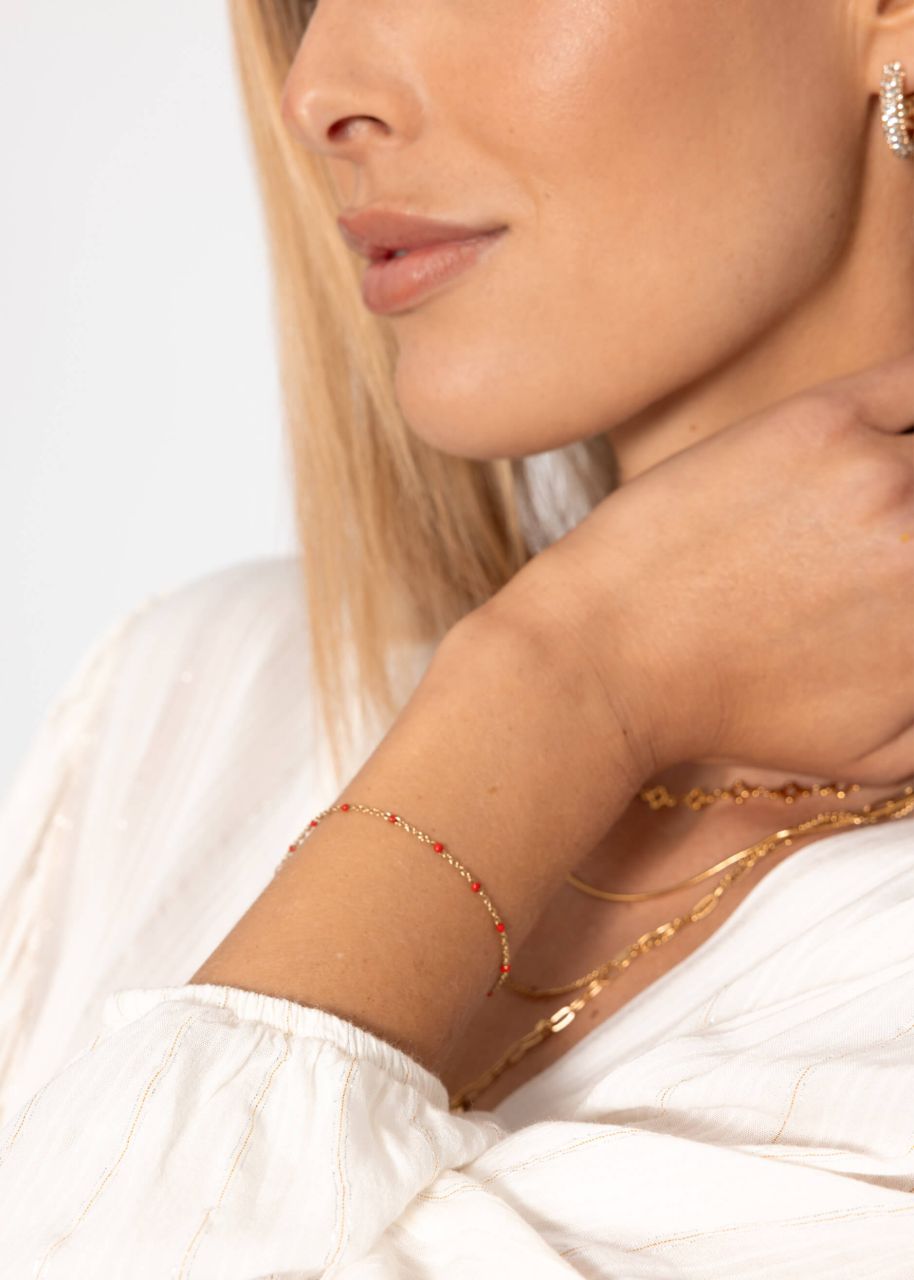 Armband mit roten Perlen - gold